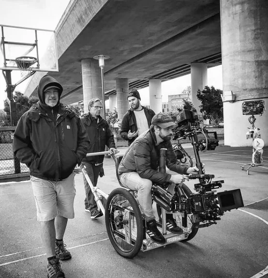 Nick Schwyter operating a stabilized camera from a wheelchair during an Apple AirPods production.